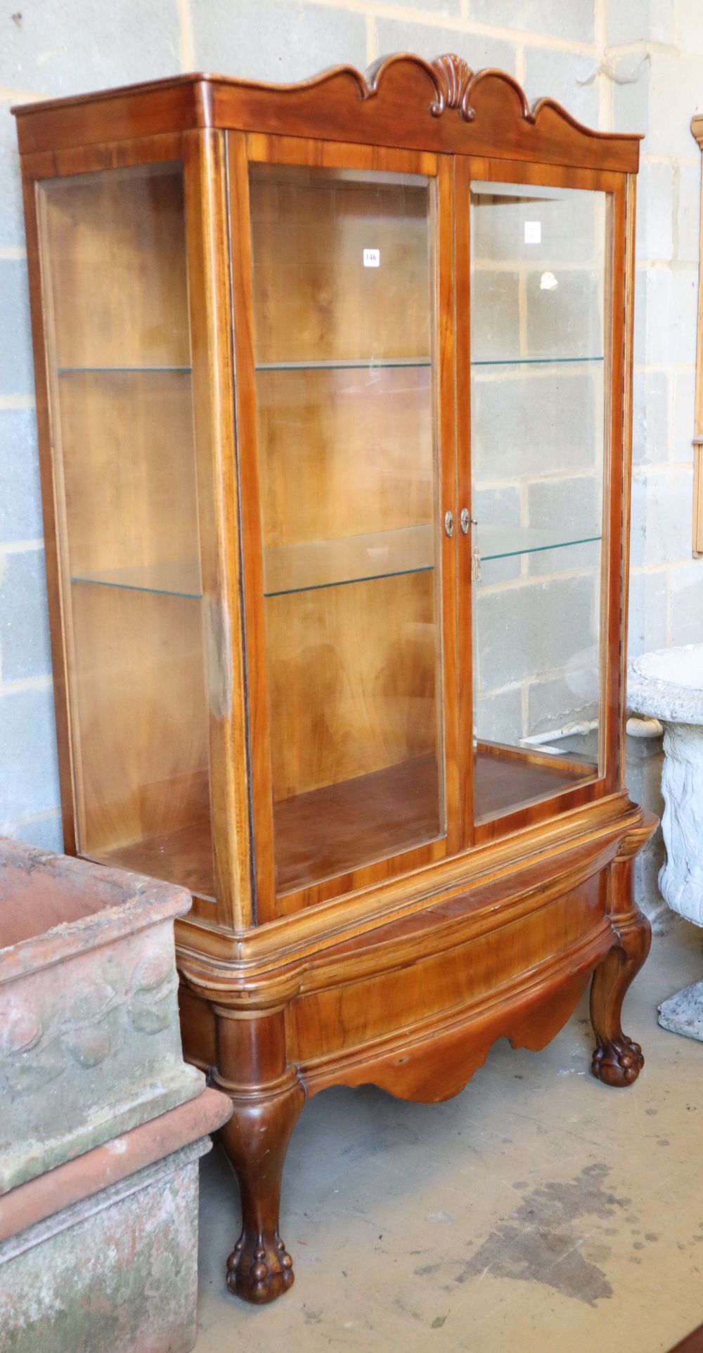 An Anglo Indian walnut two door china display cabinet, on short cabriole legs with claw and ball feet, W.112cm, H.187cm.